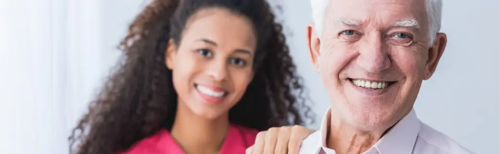 Memory care services in Greensboro NC caregiver supporting senior with Alzheimer’s in home setting