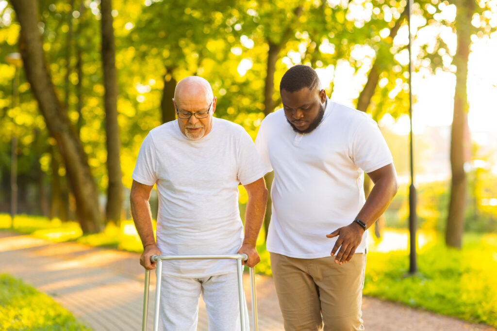 Post hospital home care in Greensboro NC caregiver assisting senior with mobility after discharge